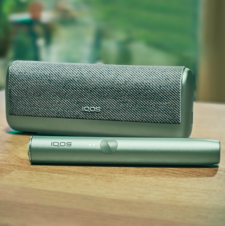 A jade green IQOS ILUMA PRIME Holder and Pocket Charger.