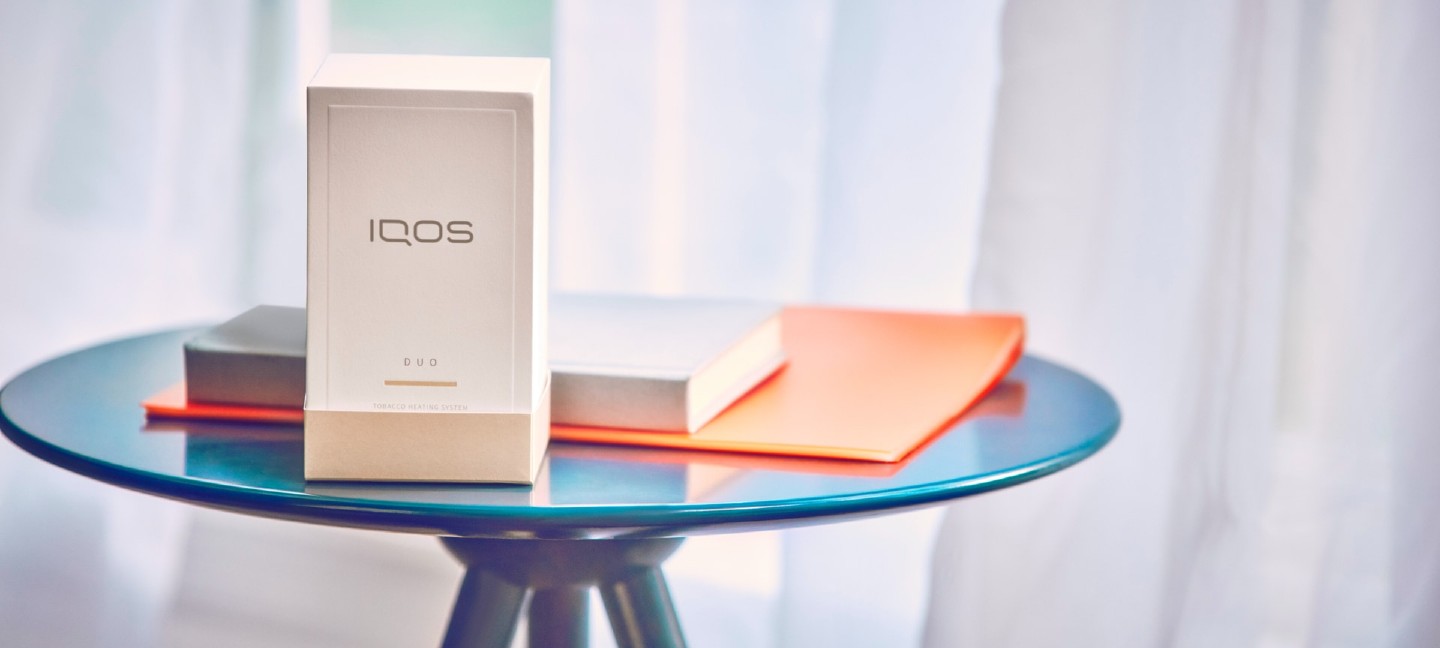 IQOS packaging on a glass table