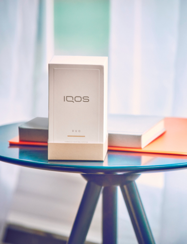 IQOS packaging on a glass table